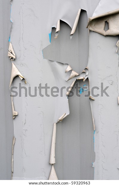 Torn ripped gray metal texture background with paint\
and metal pealing off.