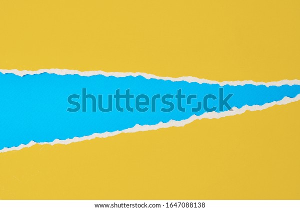 Torn ripped paper edge with copy space, color\
blue and yellow background