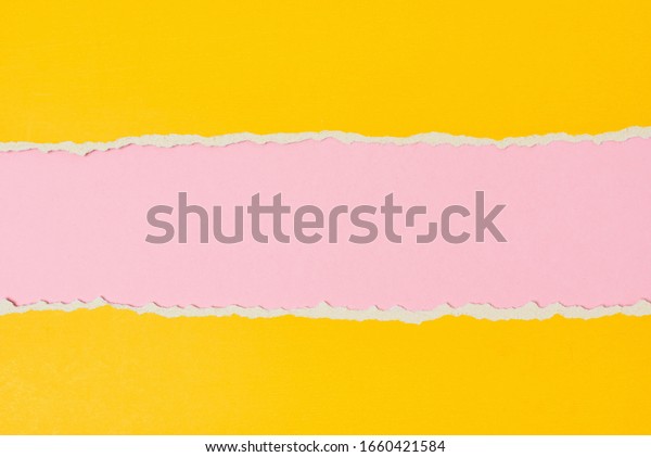 Torn ripped paper edge with copy space, pink\
and yellow color\
background
