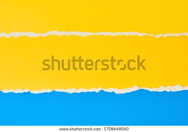 Torn ripped paper edge with copy space, color\
blue and yellow background