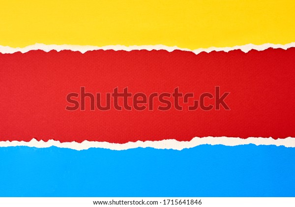 Torn ripped paper edge with copy space, red,\
blue and yellow color\
background