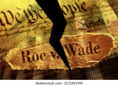 Torn Roe V Wade newspaper headline on the US Constitution with the United States Supreme Court in background                               