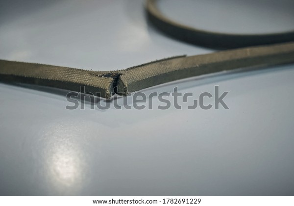 A torn rubber belt\
of belt transmission.