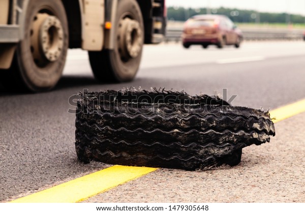 torn tire and truck on the\
highway
