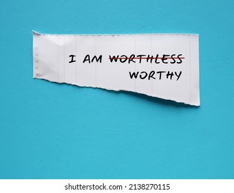 Torn White Paper On Copy Space Blue Background With Text I AM WORTHLESS Change To I AM WORTHY, Concept Of Self Talk Affirmation To Build Self Esteem And Acceptance