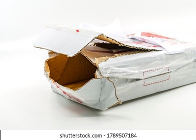 Torn White Parcel Box On White Background. Close Up Large Hole On The Parcel Box. The Stolen Internal Package Box.