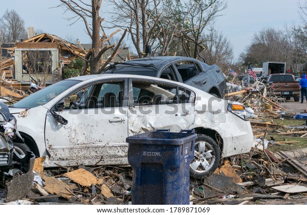 Tornado damage to cars in\
homes