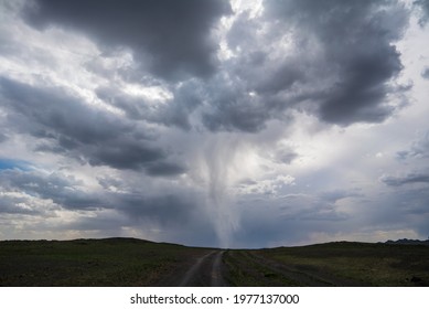 Tornado In Stormy Sky Over Dirt Road In Mongolia