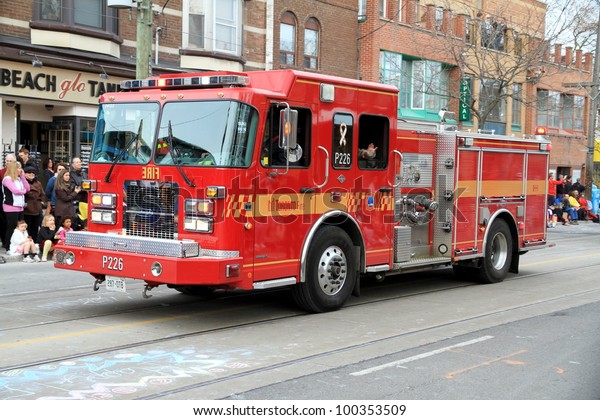 TORONTO - APRIL 8: A\
Toronto fire department vehicle during a street parade on April 8,\
2012 in Toronto. Toronto Fire Services counts on 3,100 men divided\
in 83 fire stations.