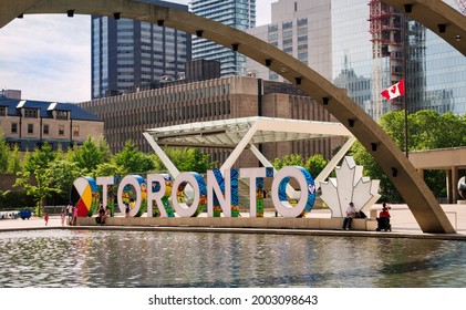 TORONTO, CANADA - 06 05 2021: Summer view on new TORONTO sign behind fountain in the heart of Toronto city - Nathan Phillips Square beside the City Hall at the intersection of Queen Street West and