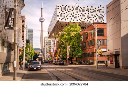 TORONTO, CANADA - 06 05 2021: Sunny Summer Day View Along McCaul Street In Downtown Toonto With Fascinating Modern OCAD University Building In Foreground And CN Tower In Background