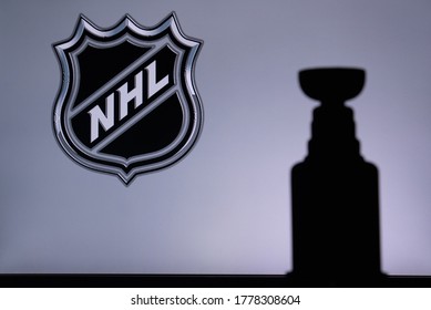 TORONTO, CANADA, 17. JULY: National Hockey LeagueLogo of NHL club on the screen. Stenley Cup Trophy Silhouette.