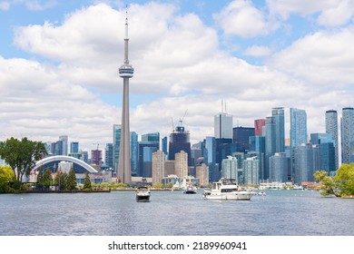 TORONTO, CANADA, 30TH JULY 22: A View Towards Part Of Toronto Downtown Skyline From Near The Toronto Islands During A Sunny Day. Boats And People Can Be Seen.