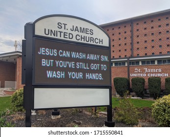 Toronto, Canada - Apr 24, 2020: Church Sign Jesus Can Wash Your Sin But You've Still Got To Wash Your Hands During Covid-19 Corona Virus Pandemic Outbreak.