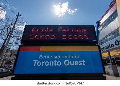 Toronto, Canada, April 02, 2020 Bilingual Secondary School Closed During COVID-19 Coronavirus Lockdown. School Closure Sign In French And English.