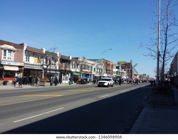Toronto, Canada - April 2015: Police car
leading the Greek parade in Danforth. The Parade organized from the
Community