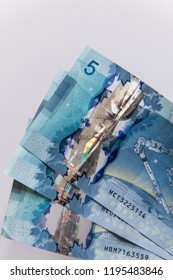 TORONTO CANADA - APRIL 8 2017: Canadian $5 Dollar Banknotes The Current Five-Canadian Dollar Note, Part Of The Frontier Series, Is Predominantly Blue 