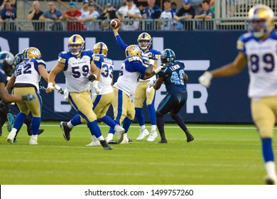 Toronto, Canada - Aug 1, 2019: Winnipeg Blue Bombers Quarterback Matt Nichols (15) Throwing Over The Defense During Winnipeg Blue Bombers At Toronto Argonauts Game At BMO Field In Toronto, ON 