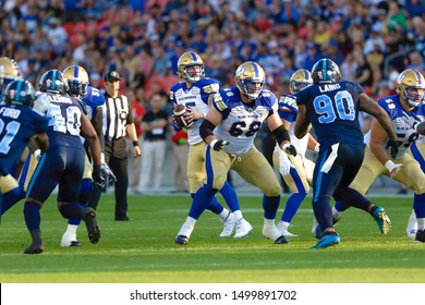 Toronto, Canada - Aug 1, 2019: Winnipeg Blue Bombers Quarterback Matt Nichols (15) Scanning Down Field During Winnipeg Blue Bombers At Toronto Argonauts Game At BMO Field In Toronto, ON