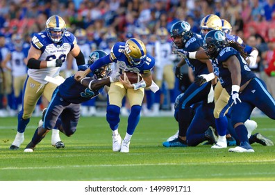 Toronto, Canada - Aug 1, 2019: Winnipeg Blue Bombers Quarterback Matt Nichols (15) Getting Sacked During Winnipeg Blue Bombers At Toronto Argonauts Game At BMO Field In Toronto, ON 