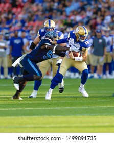 Toronto, Canada - Aug 1, 2019: Winnipeg Blue Bombers Quarterback Matt Nichols (15) Getting Sacked During Winnipeg Blue Bombers At Toronto Argonauts Game At BMO Field In Toronto, ON 