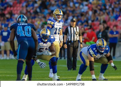 Toronto, Canada - Aug 1, 2019: Winnipeg Blue Bombers Quarterback Matt Nichols (15) During The Snap Count In Winnipeg Blue Bombers At Toronto Argonauts Game At BMO Field In Toronto, ON 