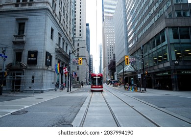 TORONTO, CANADA - Aug 11, 2021: A Vanishing Point Shot A Red Tram Visible In Toronto Downtown Near King Street In Canada