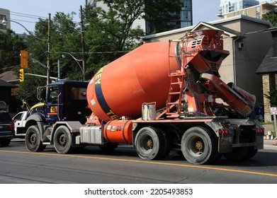 Toronto Canada Aug. 2018 Orange Color Concrete Cement Mixer Truck During Daytime Cement Mixer On The Road