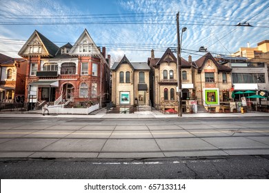 TORONTO, CANADA. December 26, 2014: Chinatown in Toronto, Canada. Urban street in the city center. Houses and dwellings in line with activities and shops. Front photo. Blue sky with some clouds.
