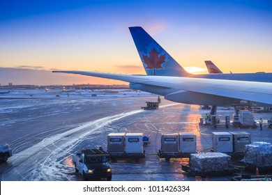 TORONTO, CANADA - DECEMBER 28, 2017: The golden light of dawn shines on an Air Canada Boeing 787 Dreamliner passenger jet being unloaded at the Toronto Pearson International Airport terminal building.
