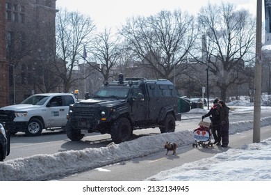 Toronto Canada Feb 13 2022: People Walking By Emergency Task Force Truck During Peaceful Protest Against Covid 19 Mandates And Restrictions And Mandatory Vaccination In Toronto City Downtown.