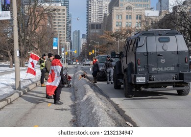 Toronto Canada Feb 13 2022: People Walking By Emergency Task Force Truck During Peaceful Protest Against Covid 19 Mandates And Restrictions And Mandatory Vaccination In Toronto City Downtown.