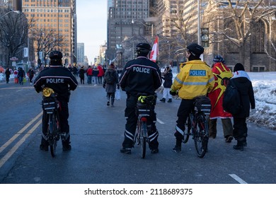 Toronto Canada Feb 5 2022: Bicycle Police At The Peaceful Protest Against Covid 19 Mandates And Restrictions And Mandatory Vaccination In Toronto City Downtown.