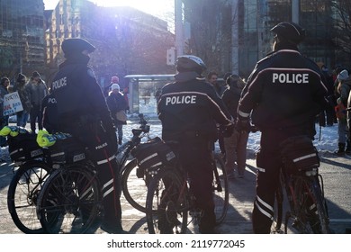 Toronto Canada Feb 5 2022: Bicycle Police Officers Patrolling Streets At Peaceful Protest Against Covid 19 Mandates And Restrictions And Mandatory Vaccination In Toronto City Downtown.