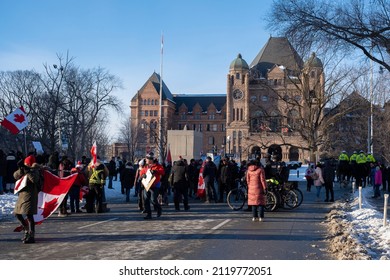 Toronto Canada Feb 5 2022: People Walking With Flags And Posters At Peaceful Protest Against Covid 19 Mandates And Restrictions And Mandatory Vaccination In Toronto City Downtown.