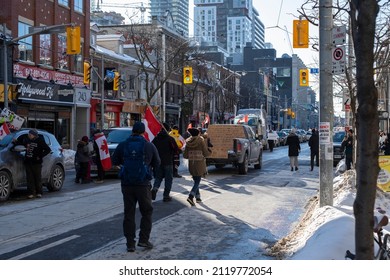 Toronto Canada Feb 5 2022: People Walking With Flags And Posters At Peaceful Protest Against Covid 19 Mandates And Restrictions And Mandatory Vaccination In Toronto City Downtown.