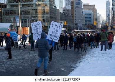 Toronto Canada Feb 5 2022: Man Holding Sign End The Vax Mandates Now At Peaceful Protest Against Covid 19 Mandates And Restrictions And Mandatory Vaccination In Toronto City Downtown.