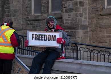 Toronto Canada Feb 5 2022: Young Happy Man Holding Sign Freedom At Peaceful Protest Against Covid 19 Mandates And Restrictions And Mandatory Vaccination In Toronto City Downtown.