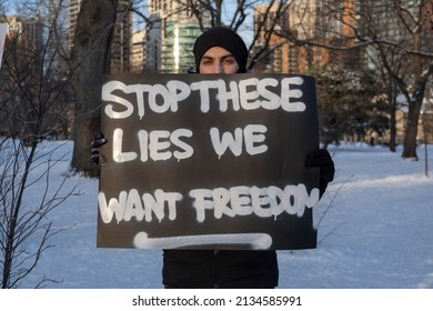 Toronto Canada Feb 5 2022: A Young Man Holding A Sign Stop These Lies We Want Freedom At Peaceful Protest Against Covid 19 Mandates. Media Propaganda, Misinformation, Disinformation, Distrust Concept.