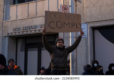 Toronto Canada Feb 5 2022: Young Man Holding Sign Do Not Comply  At Peaceful Protest Against Covid 19 Mandates And Restrictions And Mandatory Vaccination In Toronto City Downtown.