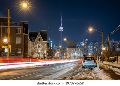 Toronto, Canada - February 21, 2021 : Car Light Trails In West Queen West Leading Towards The Toronto Skyline And CN Tower - Winter Snow 