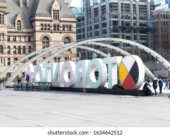 Toronto, Canada, February 3, 2020; Toronto City Hall Skating Rink With The Illuminated Toronto Sign From The Back In Winter