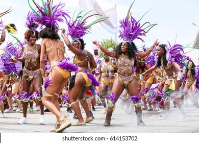 TORONTO, CANADA - JULY 20, 2016: People Dancing And Marching At The Toronto Caribbean Carnival, Formerly Called Caribana, A Festival Of Caribbean Culture And Traditions Held Each Summer.