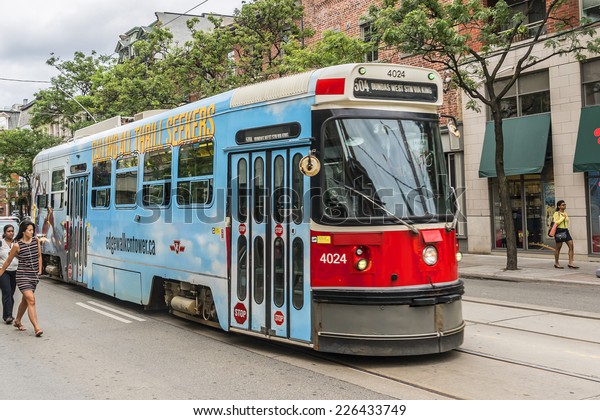 TORONTO,\
CANADA - JULY 23, 2014: City transportation streetcar. Toronto\
streetcar system comprises eleven streetcar routes in Toronto,\
operated by Toronto Transit Commission\
(TTC).
