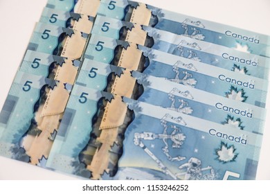 TORONTO CANADA - JULY 30, 2018: Canadian $5 Dollar Banknotes. The Current Five-Canadian Dollar Note, Part Of The Frontier Series, Is Predominantly Blue In Color