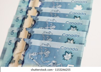 TORONTO CANADA - JULY 30, 2018: Canadian $5 Dollar Banknotes. The Current Five-Canadian Dollar Note, Part Of The Frontier Series, Is Predominantly Blue In Color