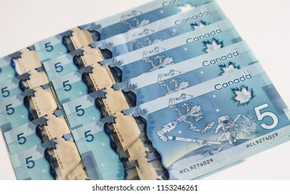 TORONTO CANADA - JULY 30, 2018: Canadian $5 Dollar Banknotes. The Current Five-Canadian Dollar Note, Part Of The Frontier Series, Is Predominantly Blue In Color