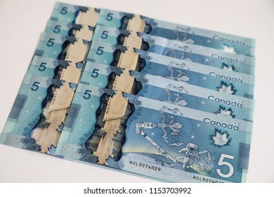 TORONTO CANADA - JULY 30, 2018: Canadian $5 Dollar Banknotes. The Current Five-Canadian Dollar Note, Part Of The Frontier Series, Is Predominantly Blue In Color