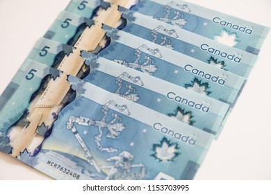 TORONTO CANADA - JULY 30, 2018: Canadian $5 Dollar Banknotes. The Current Five-Canadian Dollar Note, Part Of The Frontier Series, Is Predominantly Blue In Color