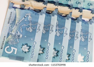 TORONTO CANADA - JULY 30, 2018: Canadian $5 Dollar Banknotes. The Current Five-Canadian Dollar Note, Part Of The Frontier Series, Is Predominantly Blue In Color